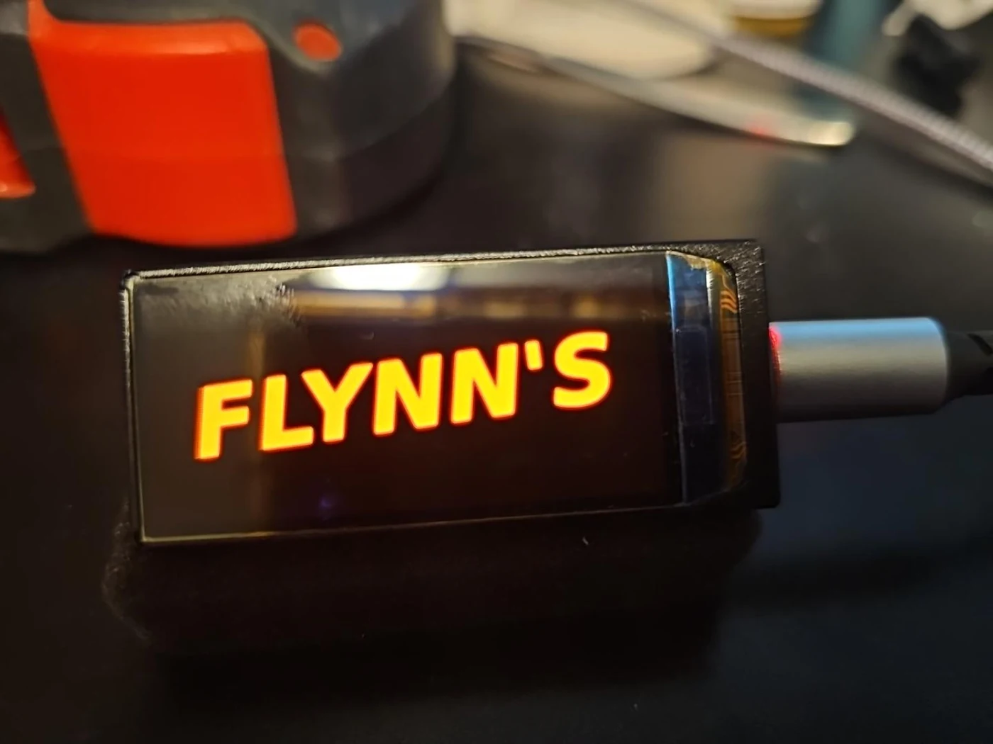 Photograph of the completed illuminated FLYNN’S sign